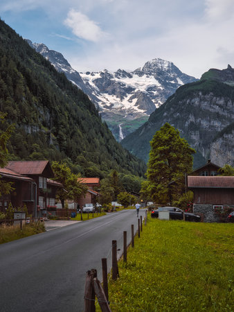 Swiss Alps Village with Mountain Peaks and Waterfall