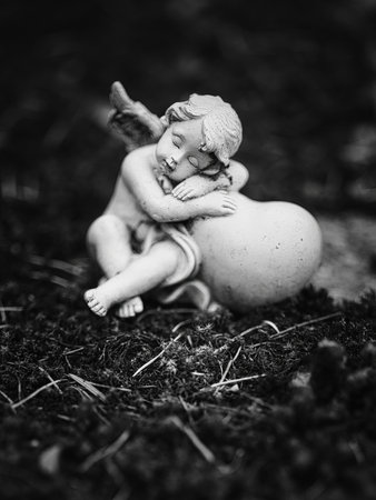 Sleeping angel statue holding a heart â Bratislavaの写真素材