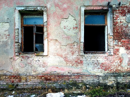 brick wall with two windowsの写真素材
