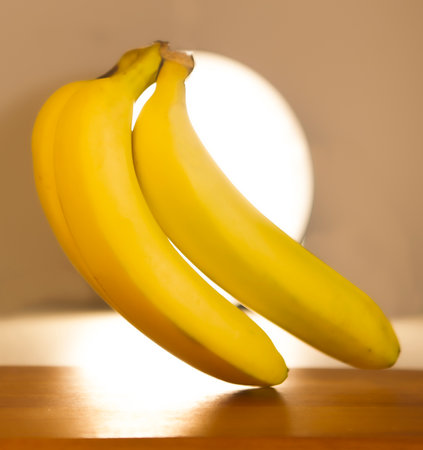 Bunch of bananas on a wooden table. Blurred background.の写真素材