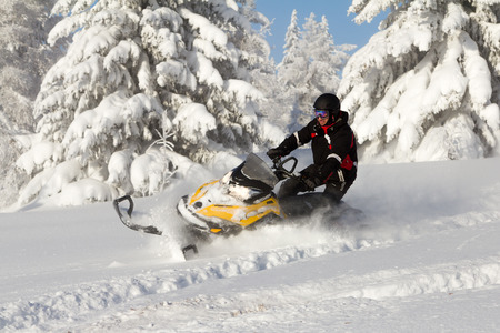 Athlete on a snowmobile moving in the winter forest in the mountains of the Southern Urals.のeditorial素材