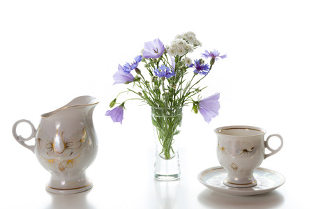 Morning coffee  and a bouquet in a vase on a white table.の写真素材