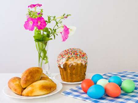 Easter eggs and Easter cake on a light background.