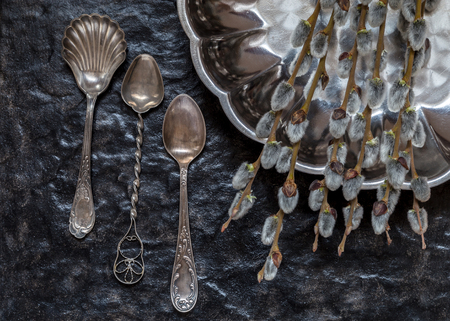 Still life with old spoons and a metal plate on a stone background.の写真素材