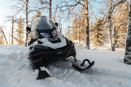 Athlete on a snowmobile moving in the winter forest in the mountains of the Southern Urals.の写真素材