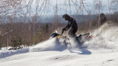 Athlete on a snowmobile.