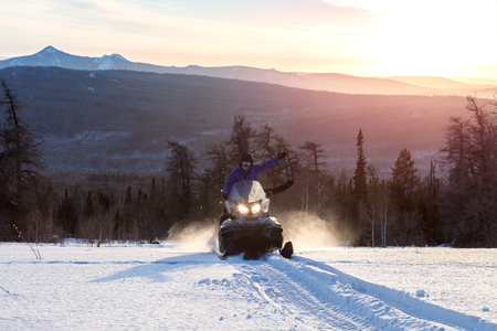 Athletes on a snowmobile.