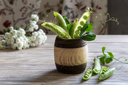 Fresh green peas on a wooden table.の写真素材