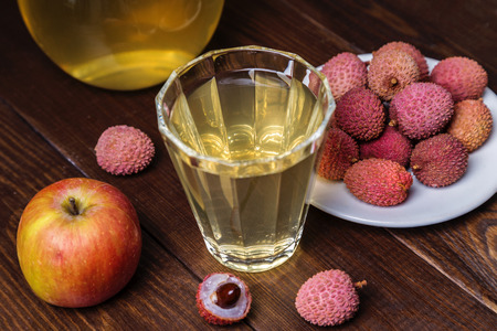 Lychee and apple juice in a glass on a dark background. Copy space.の写真素材