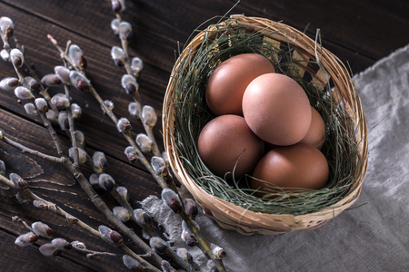 Still life with a pussy-willow and Easter eggs on a wooden background. Still life with a pussy-willow and Easter eggs on a wooden background.