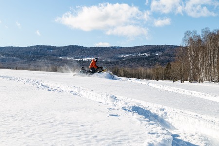 Athlete on a snowmobile moves in the winter in the mountains of the Urals.の写真素材