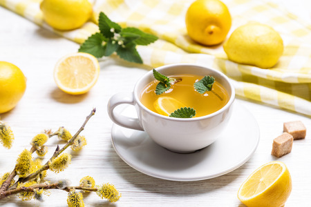 A cup of green tea with lemon and herbs.の写真素材