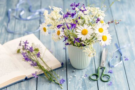 Bouquet of wild flowers on wooden background.の写真素材