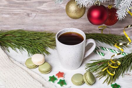 A cup of coffee and macaroons on a light background.の写真素材