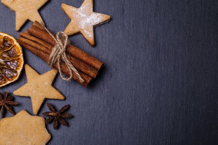 Gingerbread, cinnamon and dried oranges on a dark background. Copy spase.の写真素材