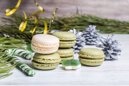 Green macaroons and Christmas caramel on a light background.の写真素材