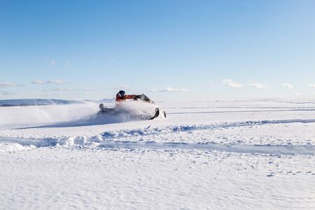 Athlete on a snowmobile moves in the winter in the mountains of the Urals.の写真素材