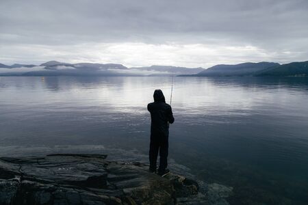 A fisherman is fishing in Norway.の写真素材