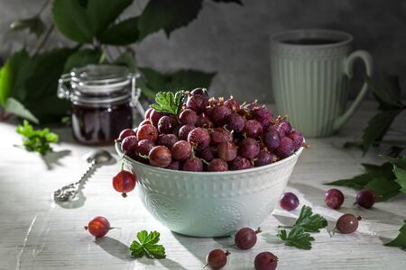 Gooseberries in a cart on a light background.の写真素材