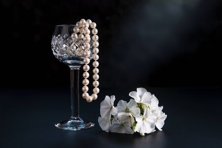 Beads from pearls in a glass, on a dark background.の写真素材