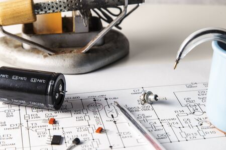 Repair of a failed appliance. Wiring diagram with radio components and a soldering iron.