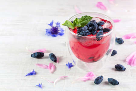 Summer pink drink with honeysuckle, and ice. Copy space.の写真素材