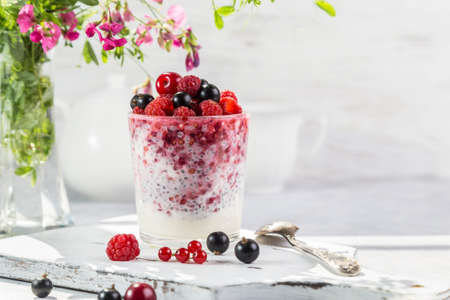 Yogurt with chia seeds and fresh berries on a light background.の写真素材