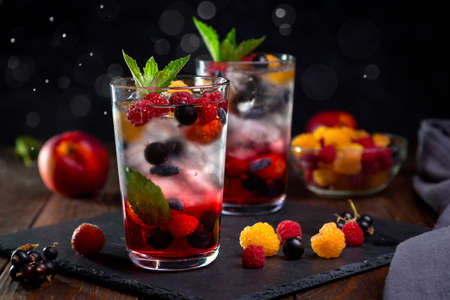 Berry lemonade in a transparent glass on a dark background.の写真素材