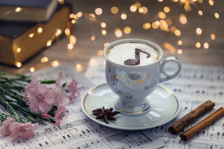 Cappuccino coffee with chocolate note and a bouquet of carnations.の写真素材