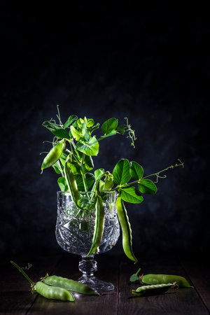 Fresh green peas on a wooden table.の写真素材