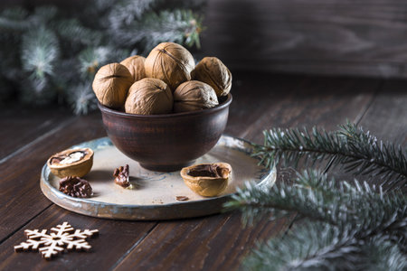 Fresh plums with mint flowers in a wooden bowl on a wooden table.の写真素材