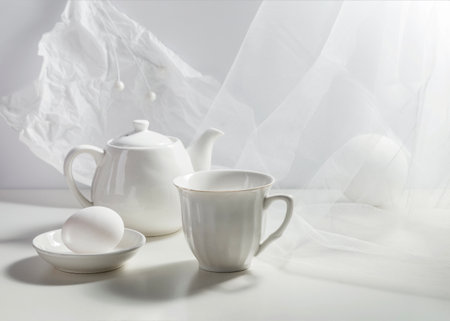 Porcelain cup and egg on a light background. Breakfast concept.の写真素材