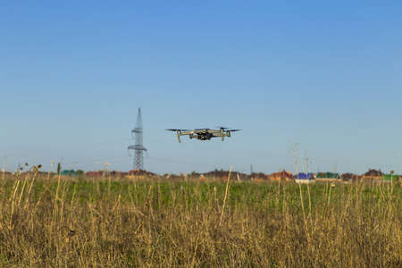 Drone in the sky. Unmanned aerial vehicle flying in the air.の写真素材