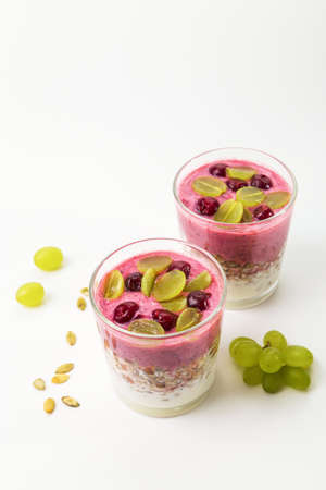Puff pastry with yoghurt, cherry smoothie, homemade granola, cherries and grapes. Healthy breakfast or snack.の写真素材