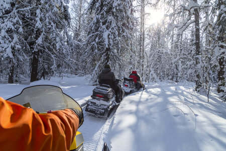 Snowmobiling in the Urals mountains on a frosty day.