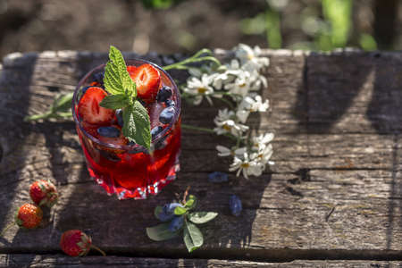Berry drink with ice on wooden boards.の写真素材