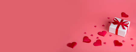 Valentine's day background with red hearts and gift. Copy space.の写真素材