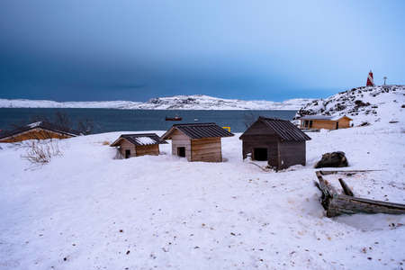 Teriberka on the coast of the Barents Sea in February. Russia. Three kennels for dogs.の写真素材