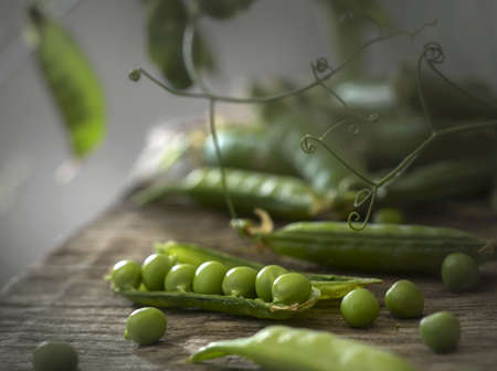 Young fresh green peas on a wooden table. selective focus.
