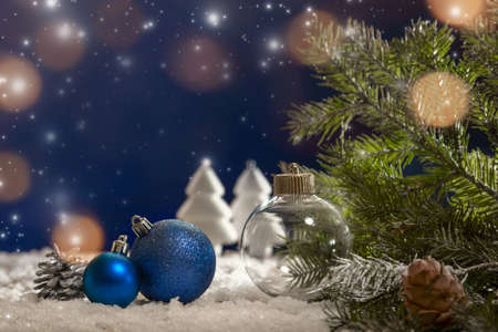 Christmas decorations on snow-covered boards with spruce twigs, cones, Christmas decorations. copyspace.の写真素材