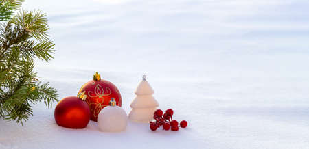 Red Christmas decorations in the snow. Christmas panoramic banner.の写真素材