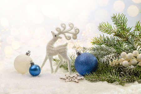 Christmas decorations under a fir tree on white snow. copyspace.の写真素材