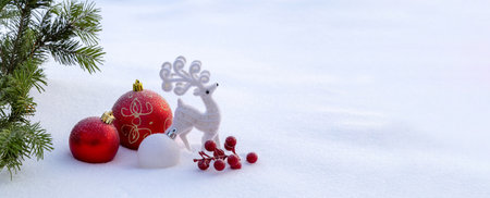 Red Christmas decorations in the snow. Christmas panoramic banner.の写真素材