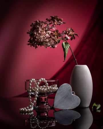 Still life with dry hydrangea and pearl necklace in a vase.の写真素材