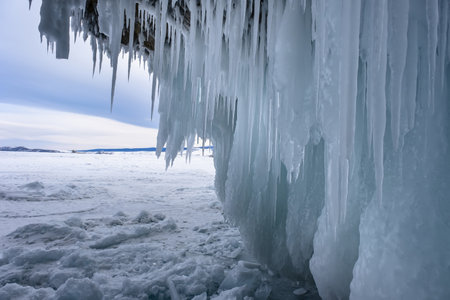 Ice grottoes and icicles on the winter lake Baikal.の写真素材