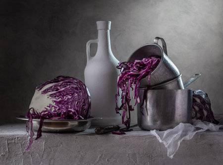 Still life with aluminum utensils and chopped red cabbage.の写真素材