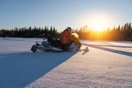 Athlete on a snowmobile moving in the winter forest in the mountains of the Southern Urals.