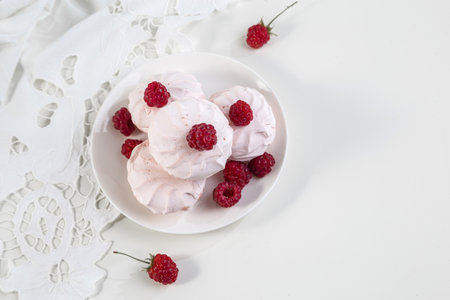 Marshmallow cookies with fresh raspberries for tea, selective focus.の写真素材