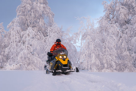 Athlete on a snowmobile moving in the winter forest in the mountains of the Southern Urals.の写真素材