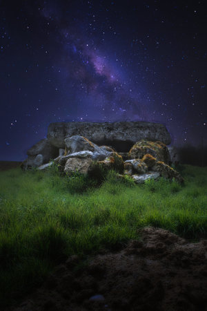 dolmen in the middle of a field, under a starry skyの写真素材